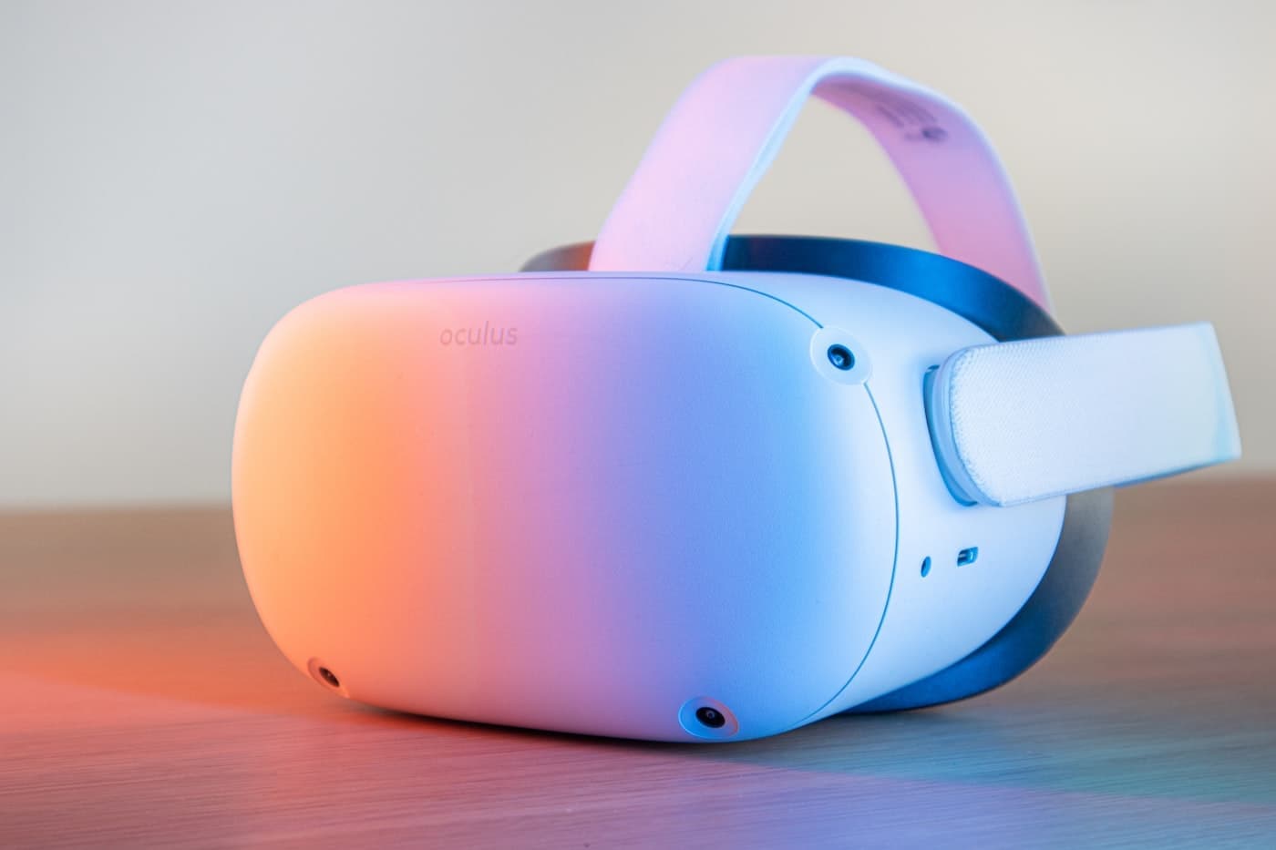 White Meta Quest VR headset in close-up with a soft pink and blue background
