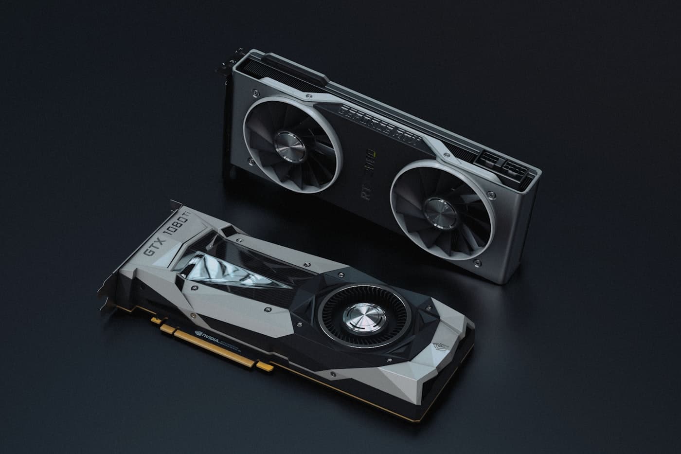 Two Nvidia Founders Edition graphics cards lying on a dark surface